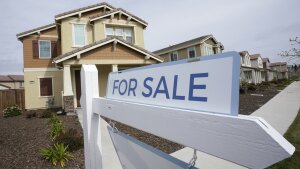 A for sale sign is posted in front of a home in SacramentoCalif. 