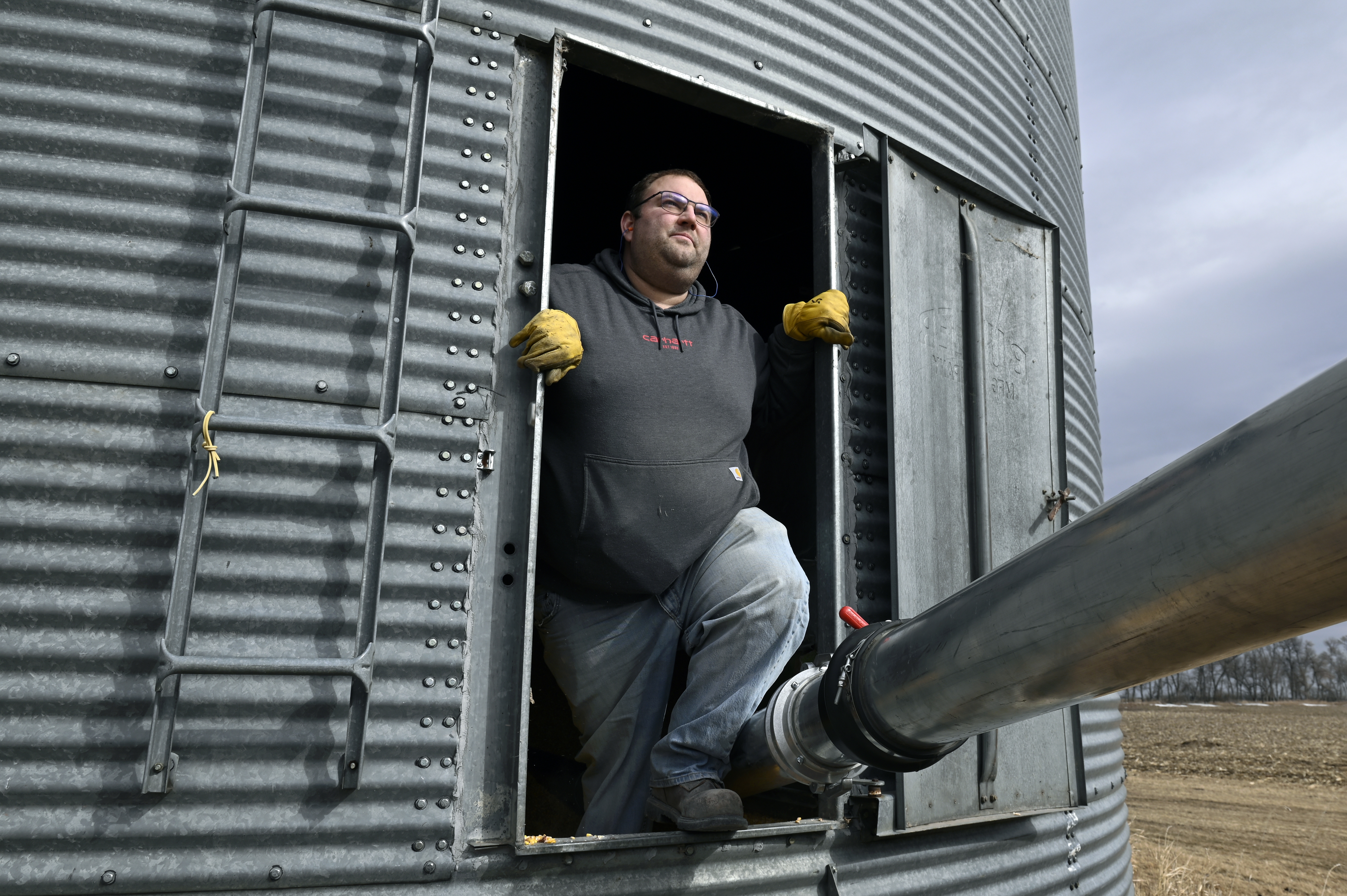 Justin Sherlock transferring corn from a storage bin to a grain truck on his farm near Wimbledon, ND.