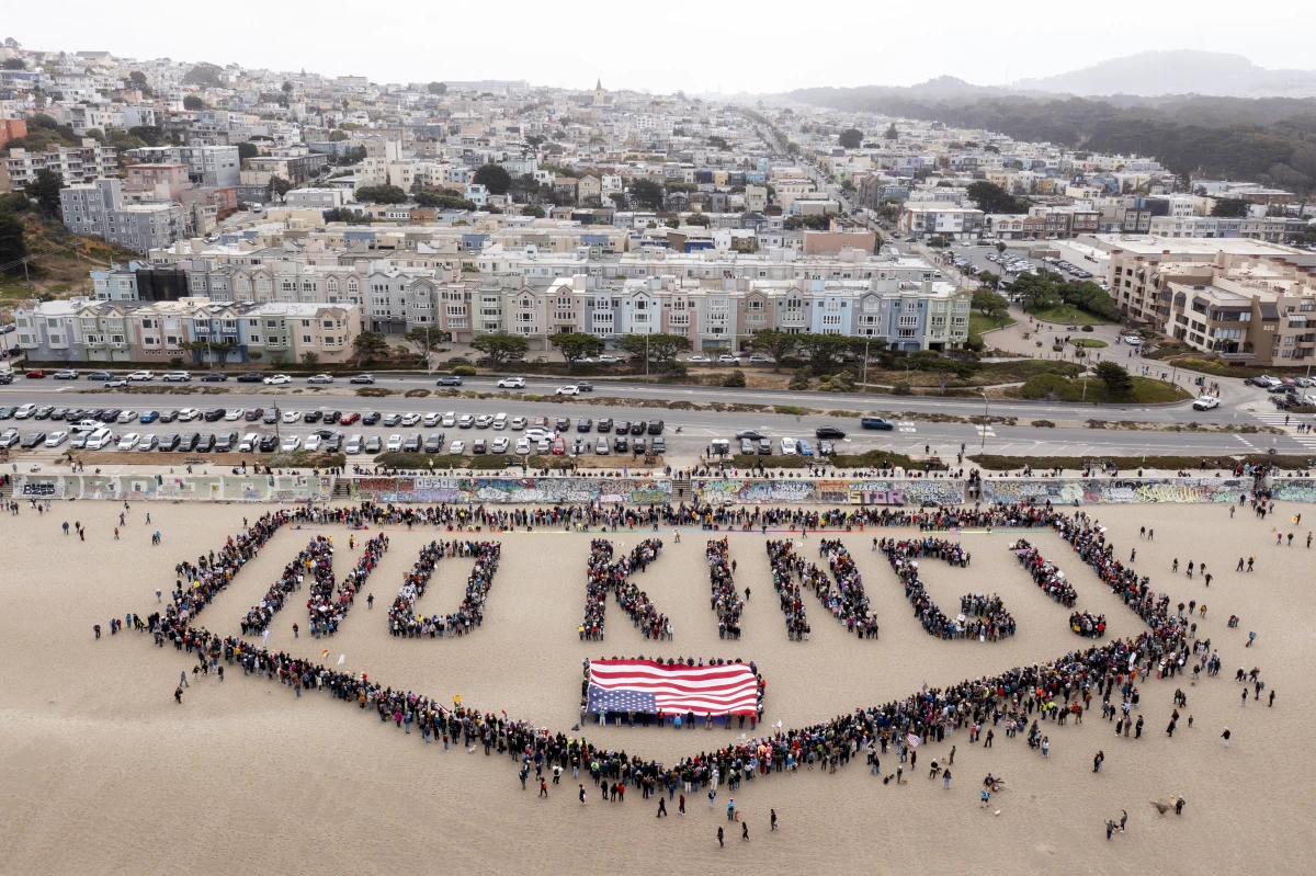 San Francisco: People form a human banner at Ocean Beach.