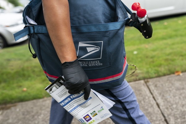 Letter carrier Connie Cruz delivers mail on October 8, 2020, in Salem, Oregon.