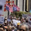 Attendees hold inverted U.S. flags, a sign of distress, during a rally organized by the Bar Association of San Francisco in support of attorneys and law firms targeted by President Donald Trump on May 1.