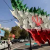 Traffic in Tehran on Wednesday moves past an installation depicting butterflies forming the Iranian national flag.