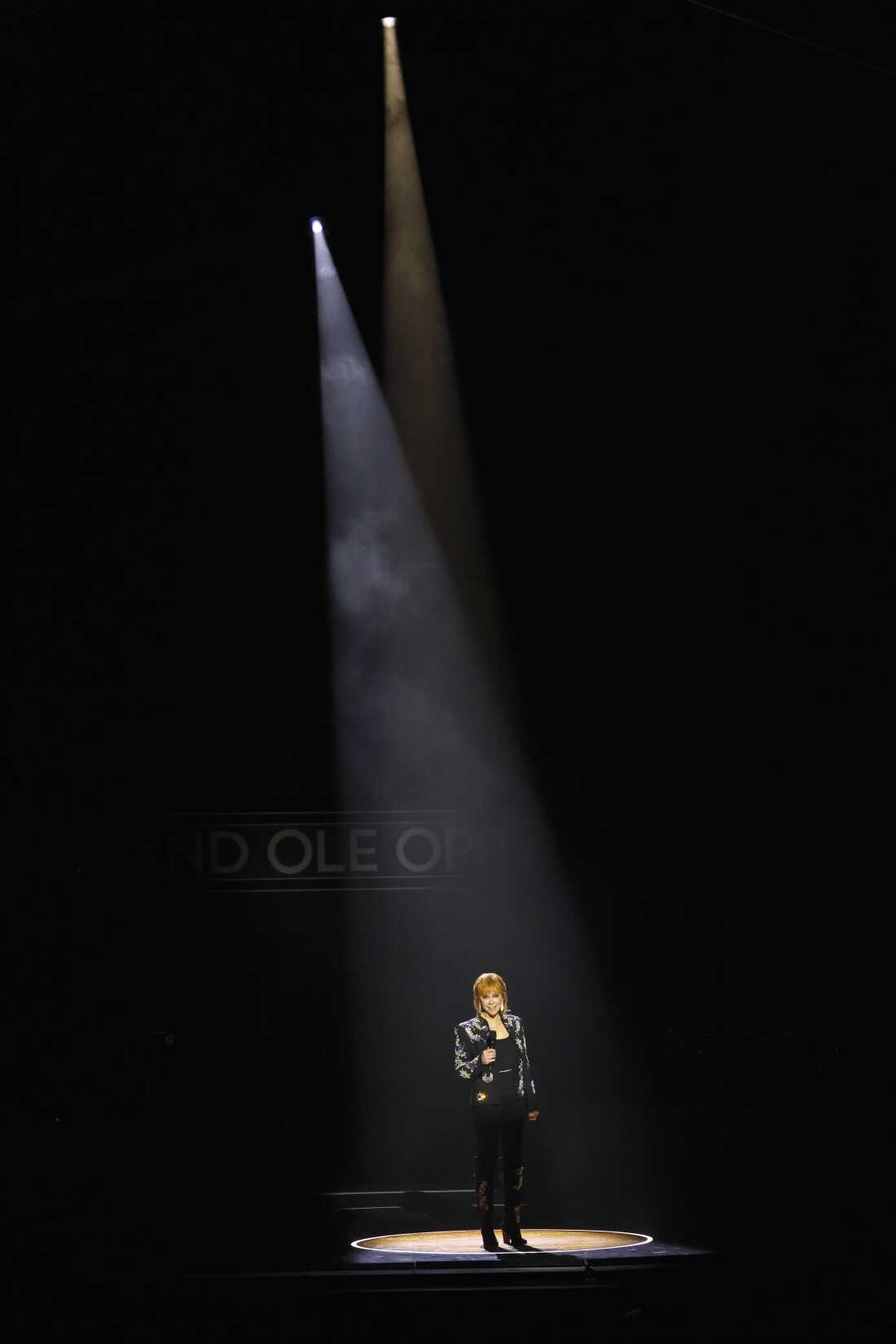 Reba McEntire stands in the circle cut from the stage of the Grand Ole Opry's early home, the Ryman Theater, during a celebration of the Opry's centennial in March, 2025.