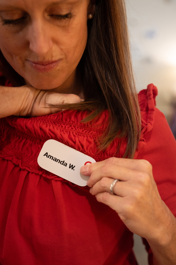 Amanda Whitworth puts on her name badge for her job at Target on July 18th.