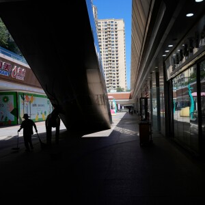 A worker collects trash in a partially shuttered Evergrande commercial complex, on the day Hong Kong Stock Exchange delisted the Chinese property developer China Evergrande, in Beijing, China, Aug. 25, 2025.