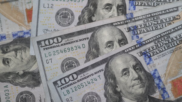 Close-ups of four $100 bills. 