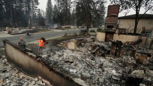 Chris Mutton, left, whose house burned in a wildfire speaks with Shane Maggart on Aug. 2, 2026, in Spokane, Wash.