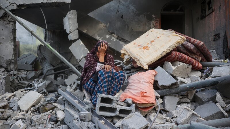 A woman cries while sitting on the rubble of her house, destroyed in an Israeli strike, in the Nuseirat refugee camp in central Gaza Strip on Tuesday. Israel on Tuesday unleashed its most intense strikes on the Gaza Strip since a January ceasefire.