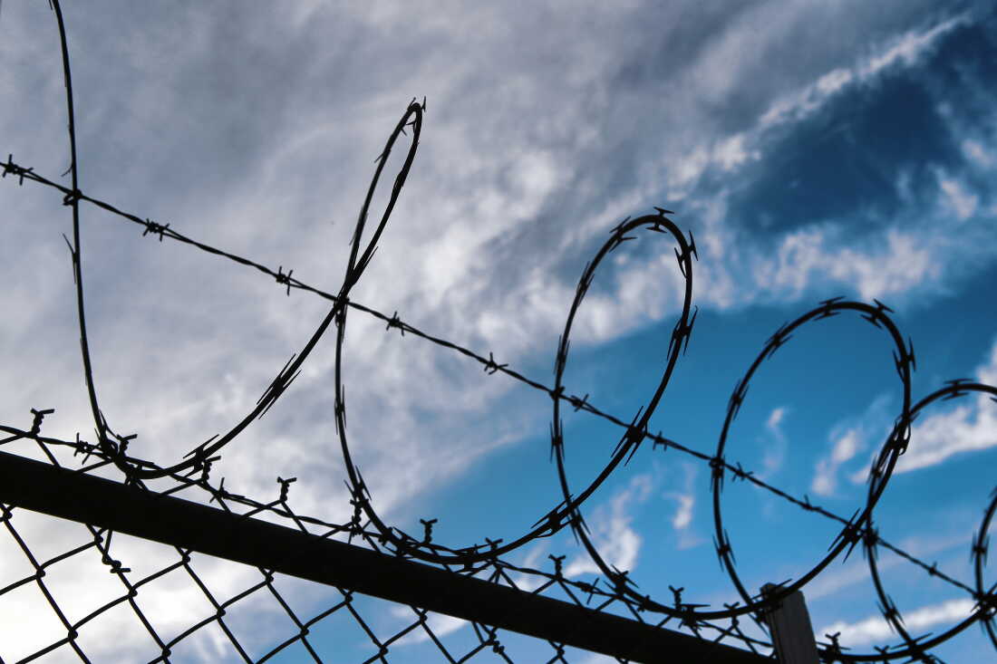 Barbed wire on top of chainlink fence. New York City, USA
