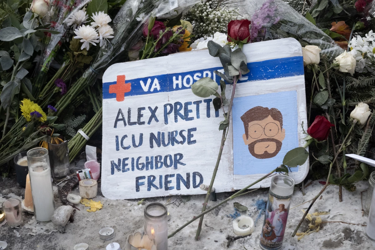 Flowers and candles make up a memorial to Alex Pretti on Jan. 25 in Minneapolis. Pretti, an ICU nurse at a VA medical center, was killed Saturday after being shot multiple times during a brief altercation with border patrol agents in the Eat Street Crossing district of Minneapolis.