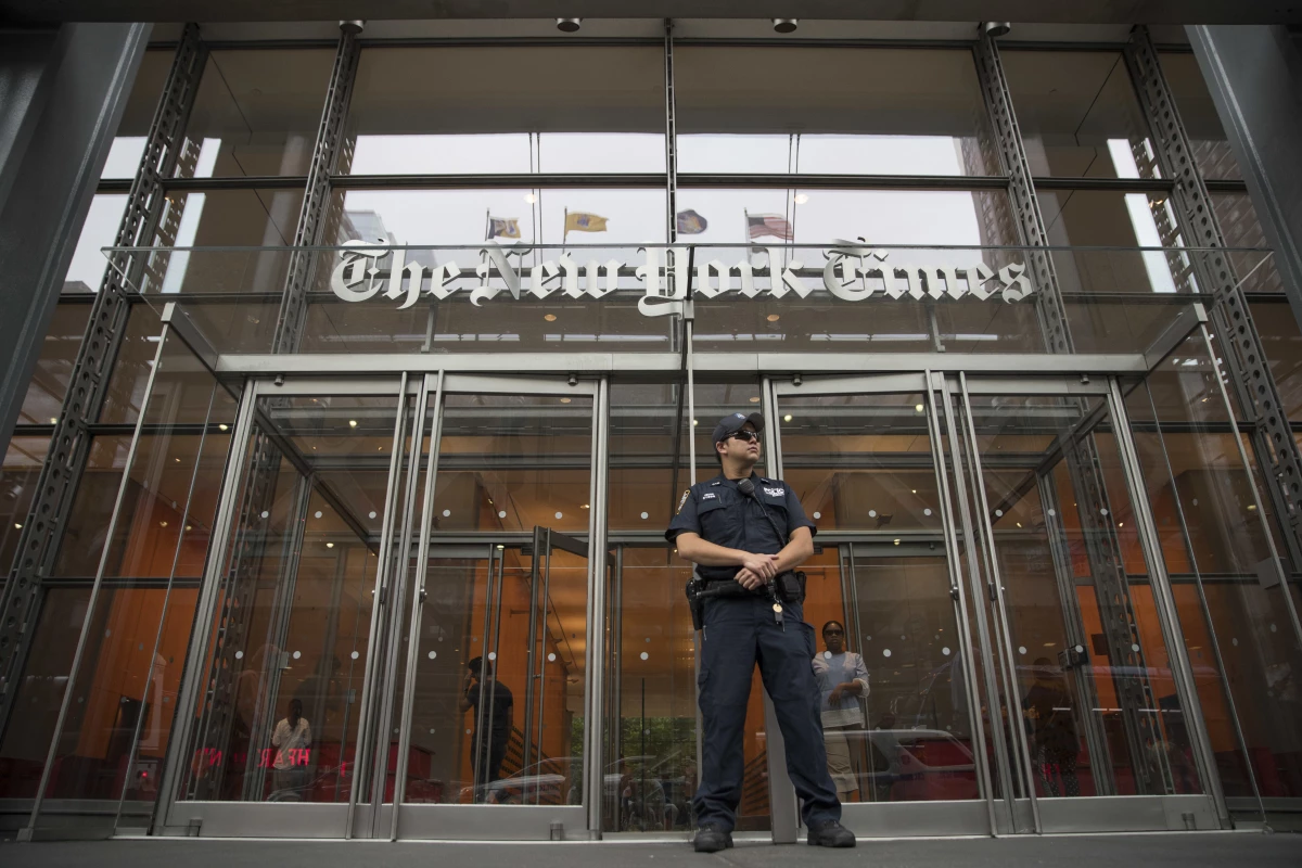 A police officer stands guard outside The New York Times building in New York, on June 28, 2018.