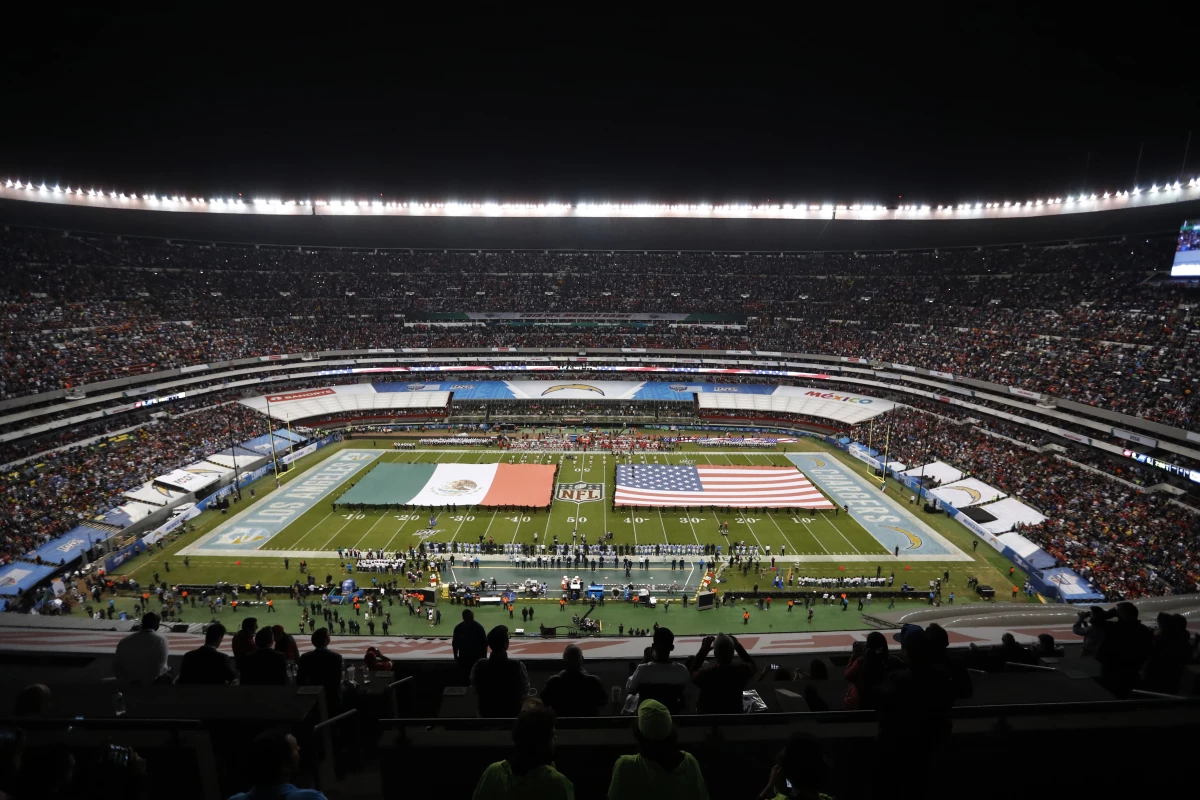 The flags of Mexico and the United States cover the field before an NFL football game between the Los Angeles Chargers and the Kansas City Chiefs Nov. 18, 2019, in Mexico City.
