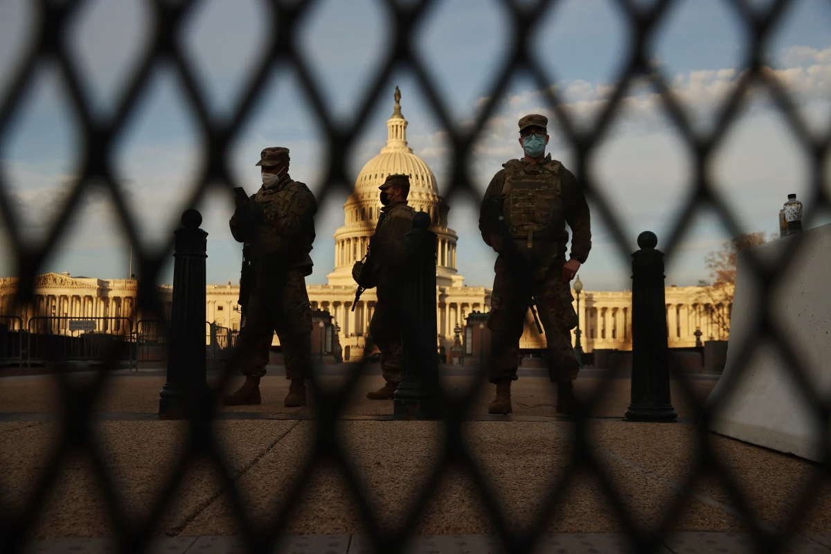 WASHINGTON, DC - JANUARY 14: Members of the New York National Guard stand guard along the fence that surrounds the U.S. Capitol the day after the House of Representatives voted to impeach President Donald Trump for the second time January 14, 2021 in Washington, DC. Thousands of National Guard troops have been activated to protect the nation's capital against threats surrounding President-elect Joe Biden’s inauguration and to prevent a repeat of last week’s deadly insurrection at the U.S. Capitol. (Photo by Chip Somodevilla/Getty Images)