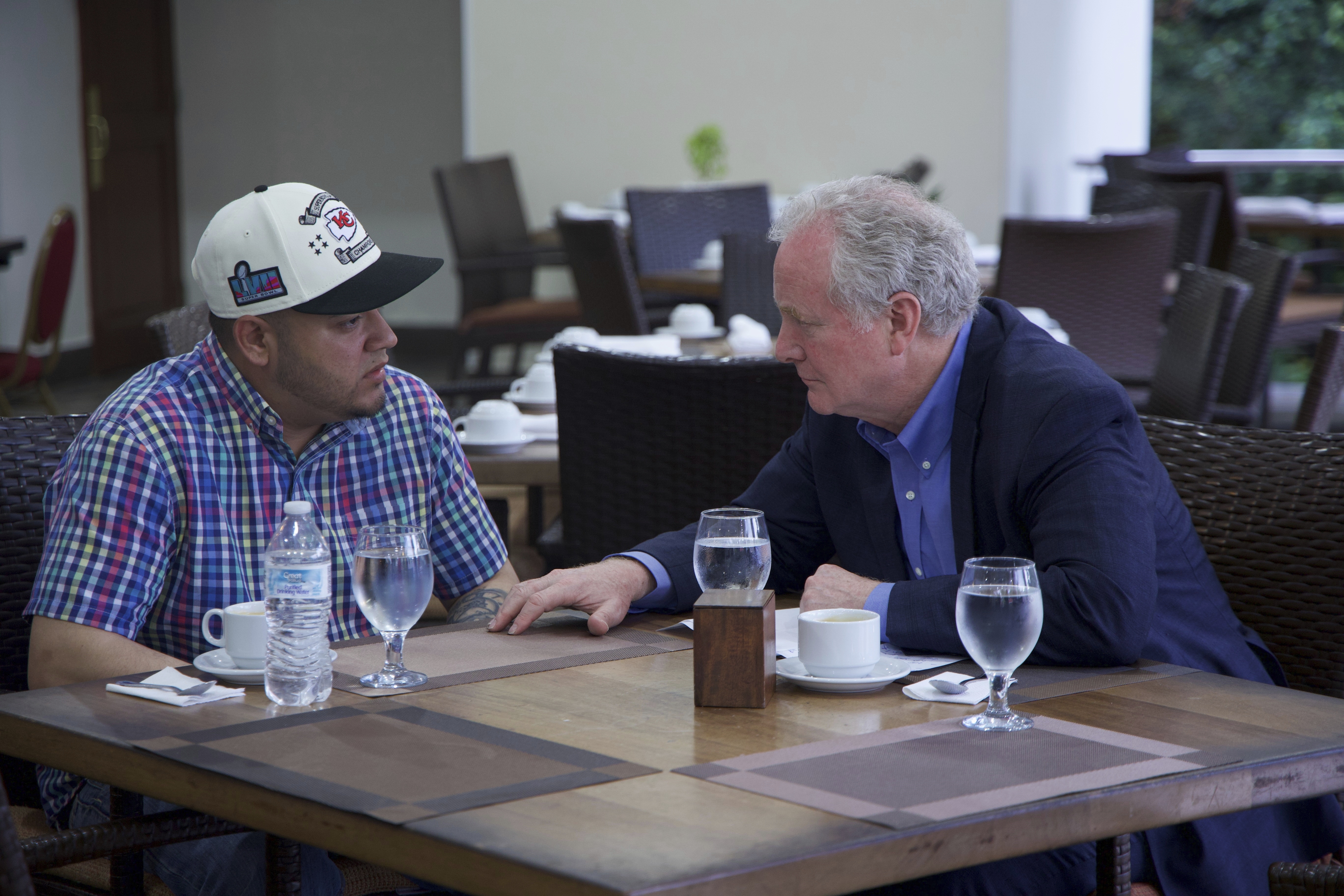 In this photo released by Senator Van Hollen's press office, Hollen, right, speaks with Kilmar Abrego Garcia, a Salvadorian citizen who was living in Maryland and deported to El Salvador by the Trump administration, in a hotel restaurant in San Salvador, El Salvador, Thursday, April 17, 2025. (Press Office Senator Van Hollen, via AP)