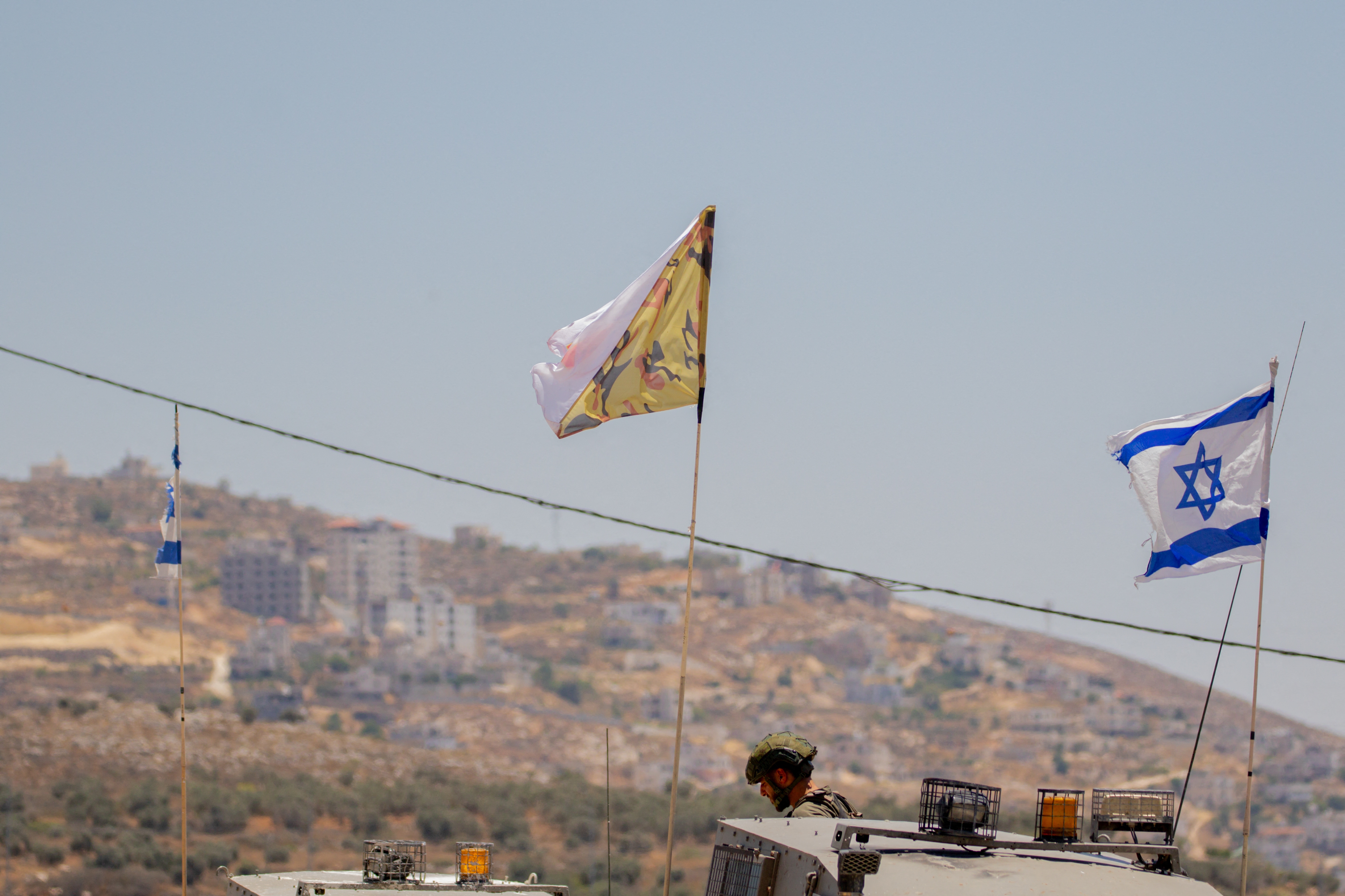 Israeli soldiers and armored vehicles near the West Bank town of Beita