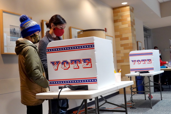Marie Guenther votes at the Bay View Library with her son on October 20, 2020 in Milwaukee, Wisconsin, which was considered a battleground state in the 2020 presidential election.