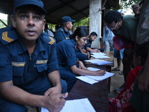 Nepal police collect details of missing people from relatives as they wait at Trishuli army camp, in Nepal's Nuwakot district.