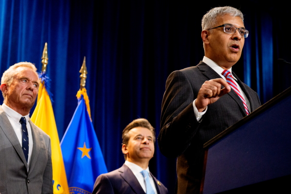 NIH Director Jay Bhattacharya (right), accompanied by HHS Secretary Robert F. Kennedy Jr. (left) and FDA Commissioner Marty Makary (center), speaks during a news conference Tuesday at the Health and Human Services Department on in Washington, D.C.