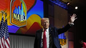 Former President Donald Trump walks off stage after speaking at the National Association of Black Journalists convention in Chicago on Wednesday.