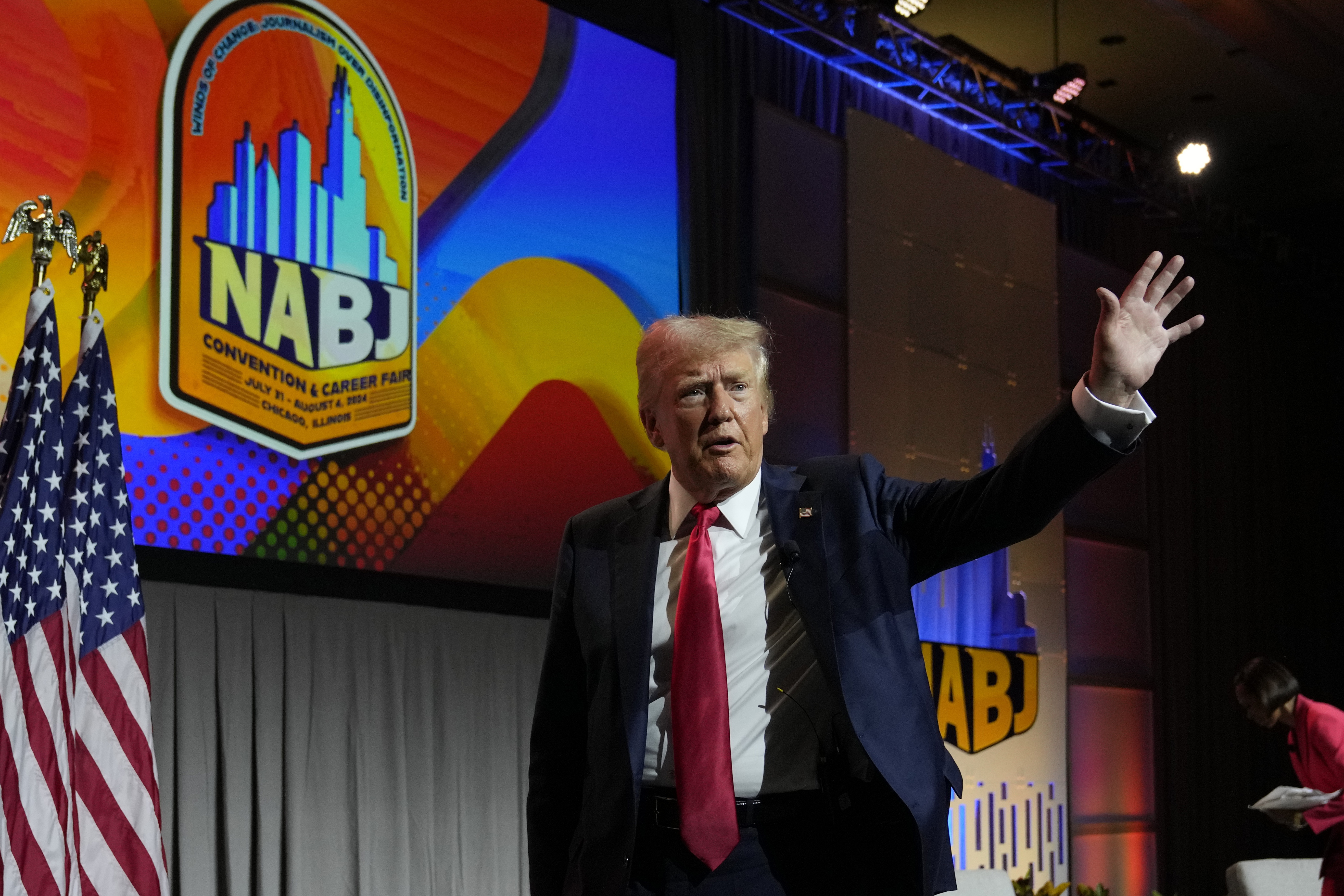 Former President Donald Trump walks off stage after speaking at the National Association of Black Journalists convention in Chicago on Wednesday.