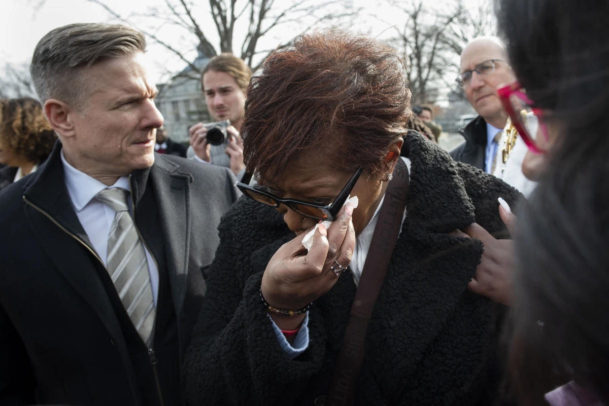 Pamela Walker, mother of Jayland Walker, who was shot and killed by police in Akron, Ohio, is comforted prior to appearing before reporters about police reform, on Capitol Hill in Washington, on Feb. 7, 2023.