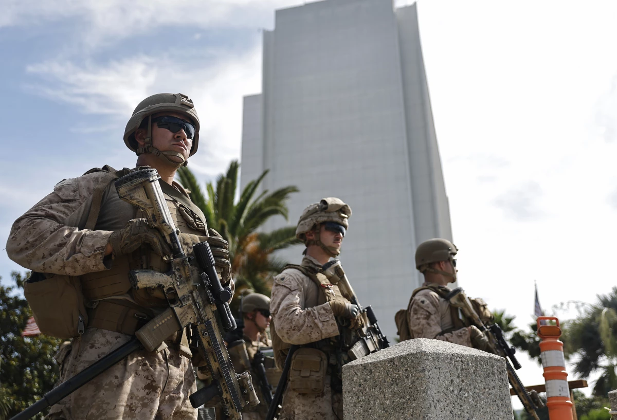 Marines stand guard at an entrance to the Wilshire Federal Building in Los Angeles on June 13, 2025.