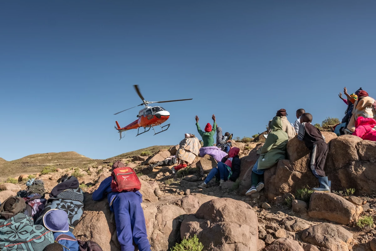 Residents of the isolated village of Mphooko wave as a team from the Lesotho Flying Doctor Service departs after a day treating patients. Mphooko is inaccessible by road and relies on the LFDS for basic medical care.