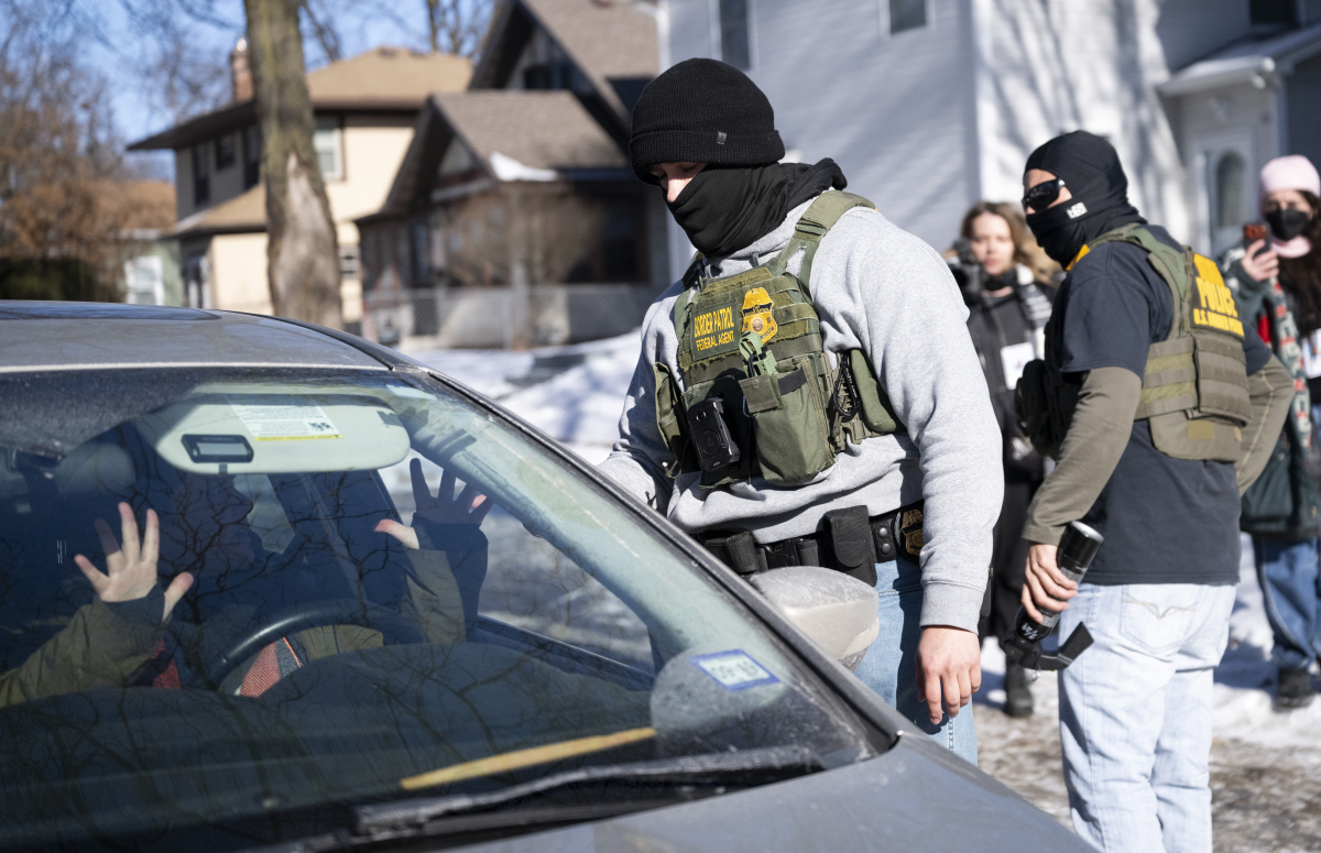A member of the U.S. Border Patrol confronts the driver of a vehicle that was following them on Jan. 29, in Minneapolis. Democrats want immigration officers to not cover their faces and wear body cameras, among other changes.