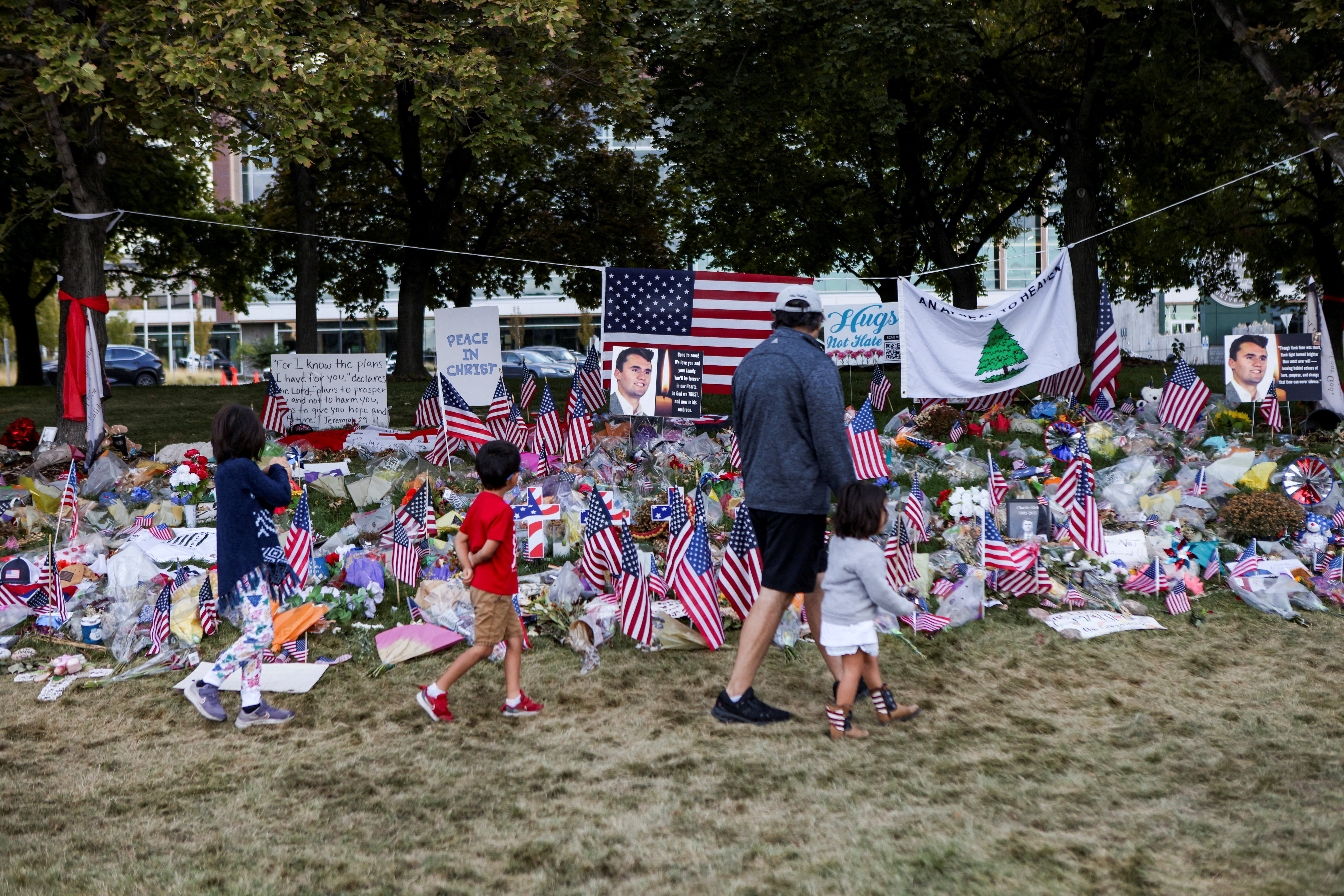People walk in front of a memorial for slain conservative commentator Charlie Kirk, at Utah Valley University in Orem, Utah, on September 29, 2025.