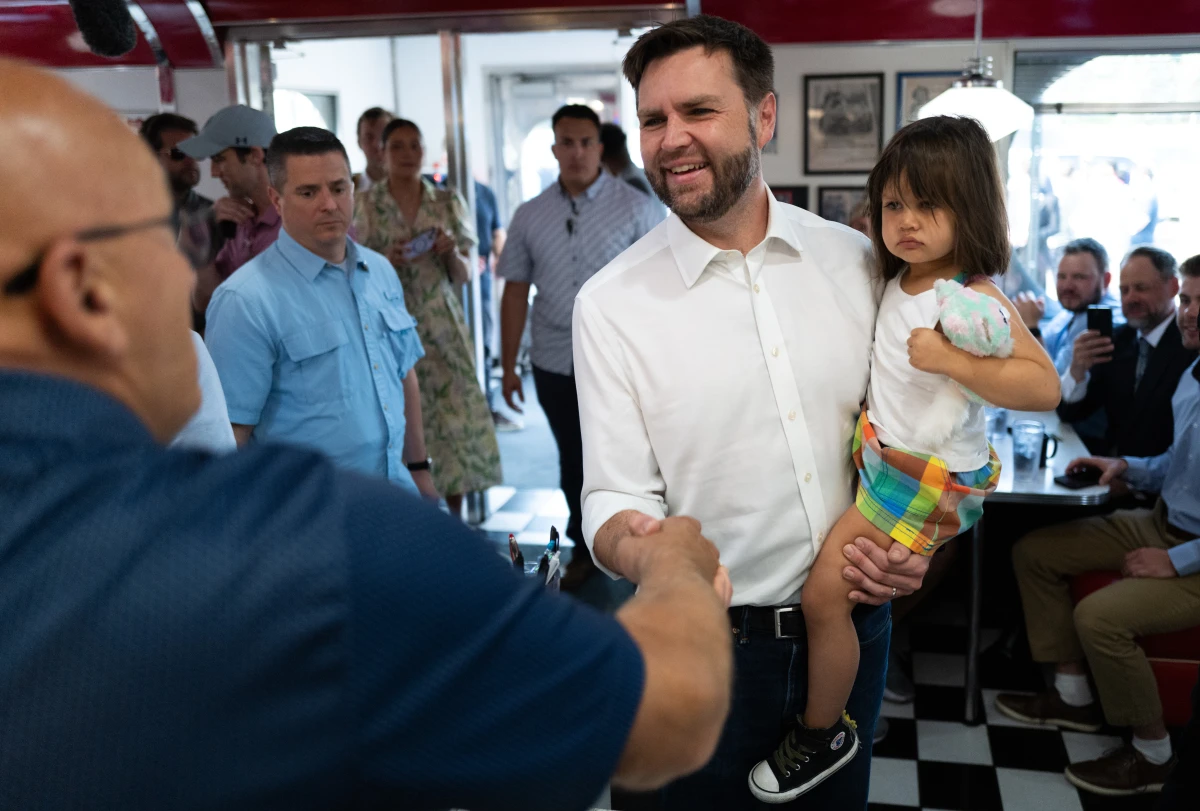 Ohio Sen. JD Vance, the Republican vice presidential nominee, carries his daughter, Maribel, on the campaign trail in St. Cloud, Minnesota. Vance and his wife, Usha, also have a young son, Vivek.