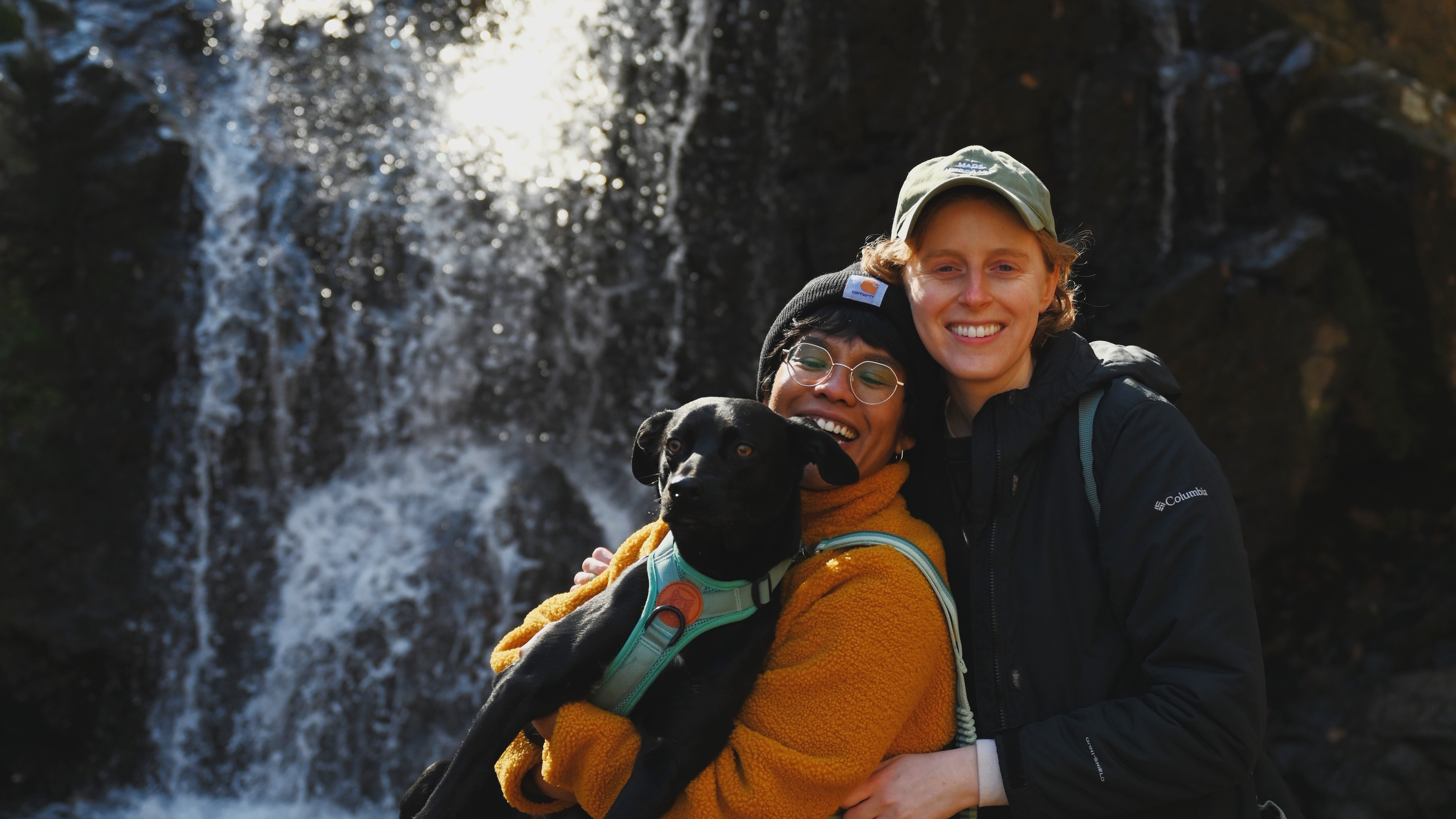 <em>Morning Edition</em> producer Julie Depenbrock and her girlfriend Amanda Gomez on a hike with their dog, Bentley. (Courtesy Ev Crunden)
