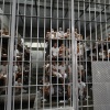 Inmates sit in a cell at El Salvador's Counter-Terrorism Confinement Centre (CECOT) mega-prison, where hundreds of gang members are incarerated, in Tecoluca on Jan. 27. The Trump administration says it is considering El Salvador's offer to accept U.S. prisoners — including some U.S. citizens — in its jails.