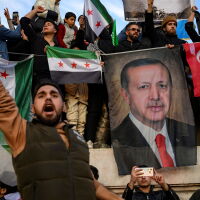 People hold a banner featuring Turkish President Recep Tayyip Erdogan as members of the Syrian community and supporters gather in Istanbul to celebrate the fall of Syrian President Bashar al-Assad in the face of an offensive by Islamist-led rebels, on Dec. 8.
