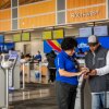 Southwest Airlines unveiled big shifts in how it does business Thursday, saying it will throw out the open-seating model it has used for decades and introduce redeye flights. Here, an employee and passenger are seen at the Austin-Bergstrom International Airport last year in Austin, Texas.