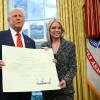 President Trump and Pam Bondi pose with the official commission signed by Trump that appoints Bondi to the position of U.S. Attorney General after she was sworn in in the Oval Office on Wednesday.