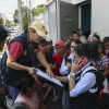 Staffers of the Attorney General's Office take the data of relatives outside of the Returnee Reception Center while waiting for the arrival of minors deported from the United States, at the Guatemalan Air Force Base in Guatemala City on August 31, 2025. (Photo by Johan ORDONEZ / AFP) (Photo by JOHAN ORDONEZ/AFP via Getty Images)