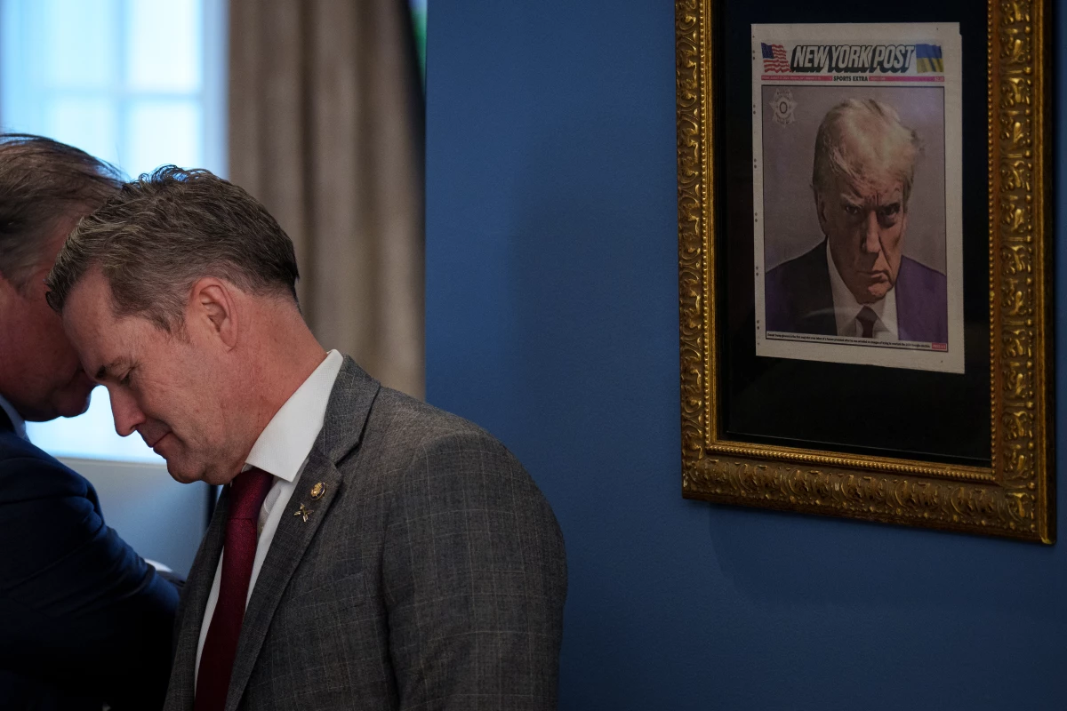 A copy of Donald Trump's mug shot on the cover of the New York Post is framed in an office just outside the Oval Office.
