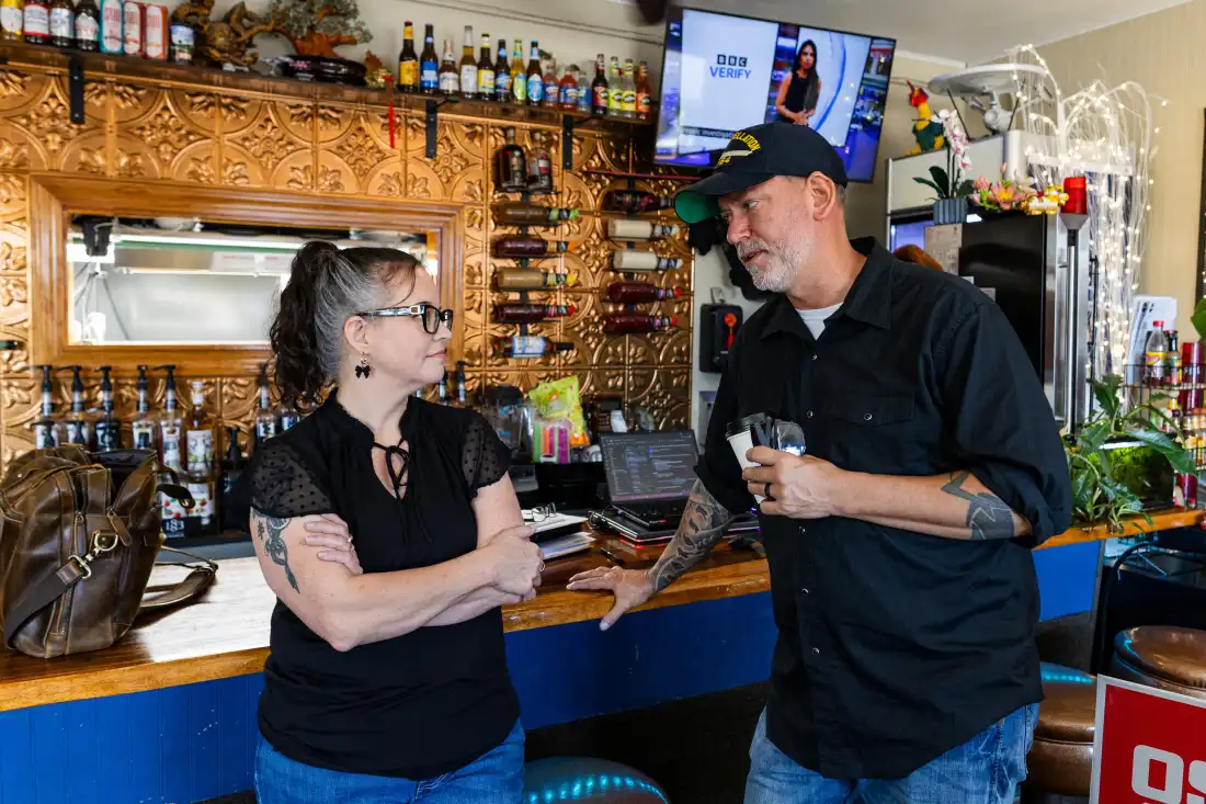 Dan Osborn, an independent candidate for U.S. Senate from Nebraska, speaks with Maranda Lee, co-owner of Lee's Crossroads Cafe, at the cafe after a town hall meeting September 3, 2026 in Arapahoe, Nebraska.