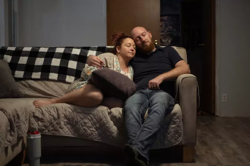 Erica and Wade Hanicker rest together on the couch after putting their two children to bed. Wade Hanicker says one of the hardest things about living with silicosis is "not being able to be a father the way I want to with my kids."