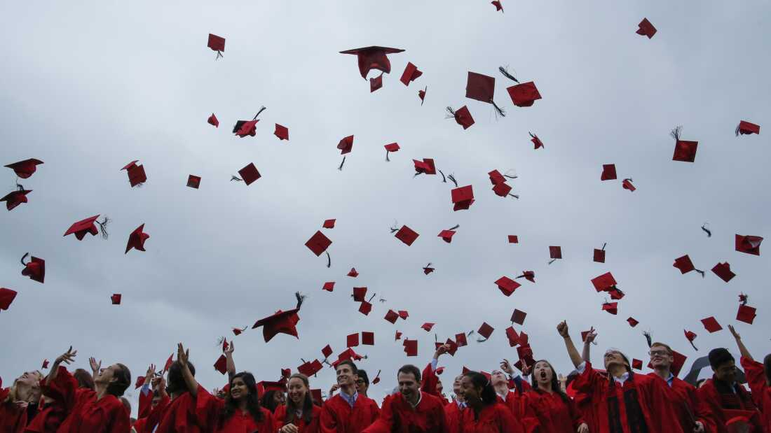 MIDDLETOWN, CT - MAY 27: Students toss their hats in the air at the conclusion of their commencement ceremony on May 27, 2018 at Wesleyan University in Middletown, Connecticut. Law professor Anita Hill spoke at the ceremony.
