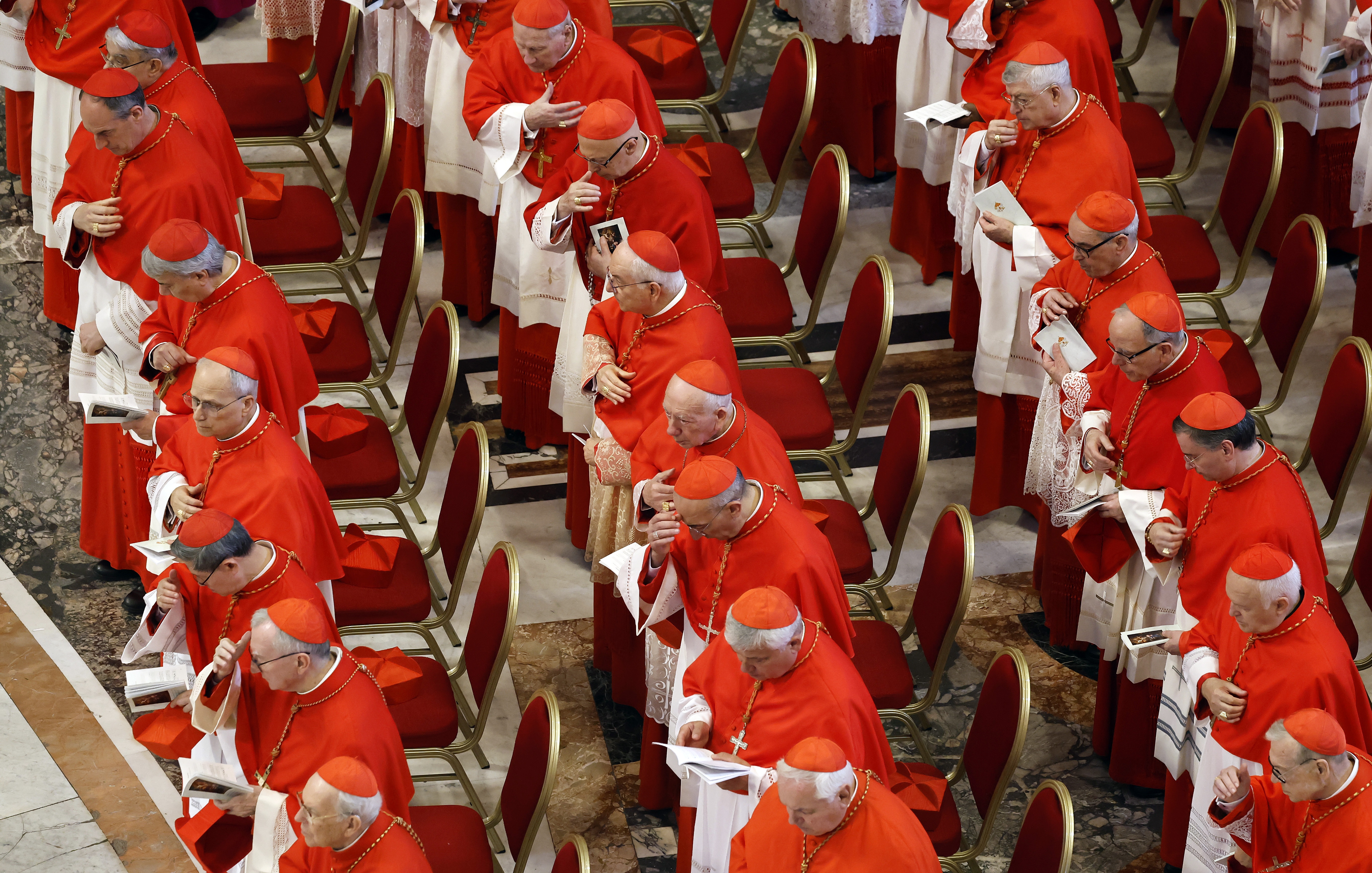 Cardinals look on as the body of Pope Francis is transferred into the Basilica at St Peter