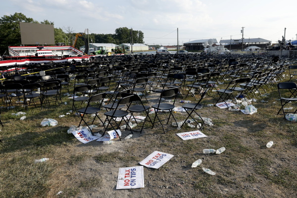 Campaign signs and empty water bottles are seen on the ground in the aftermath of the assassination attempt in Butler.
