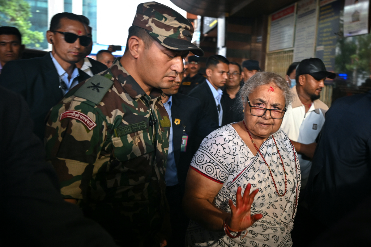 Prime minister of Nepal's interim government, Sushila Karki (front right), arrives at the National Trauma Center hospital to visit victims injured in clashes with security personnel, in Kathmandu, on Sept. 13.