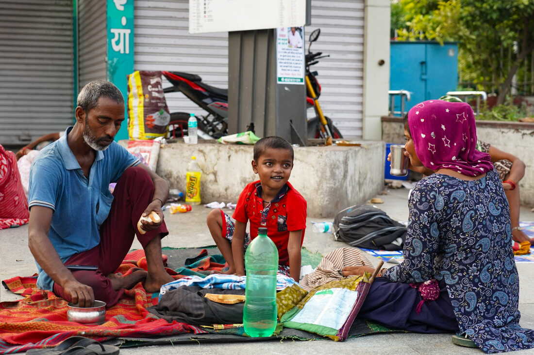 Balraam Singh, 35, eats breakfast with his wife, Nusaa Davii, and their 7-year-old son, Munna, on the pavement outside Safdarjung Hospital in New Delhi, India. The child is receiving treatment for a heart condition, and the family has been sleeping on the pavement outside the hospital for the past 20 days.