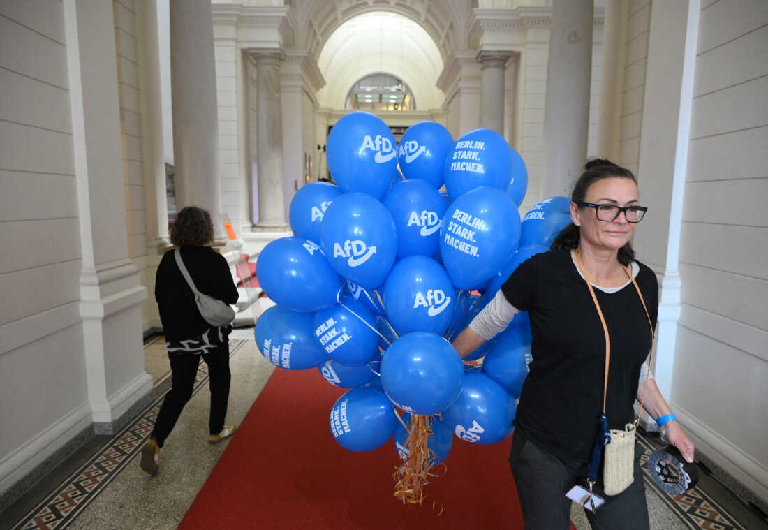 A woman holds ballons of the Germany's far-right Alternative for Germany (AfD) party to prepare the election party at the House of Representatives of Berlin during regional elections in the German capital on September 20, 2026. Germans began voting in two state elections - the capital Berlin and the northeastern federal state of Mecklenburg-Western Pomerania - where far-right and far-left gains could send new shock waves to Berlin and rock the government of embattled Chancellor Friedrich Merz.