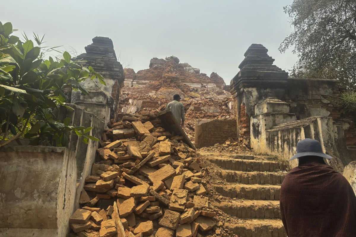 Visitors walk near damaged Maha Aungmye Bonzan Monastery, commonly known as the Me Nu Brick Monastery, in the aftermath of Friday's earthquake in Innwa, Tada-U township, Mandalay, Myanmar on Friday.