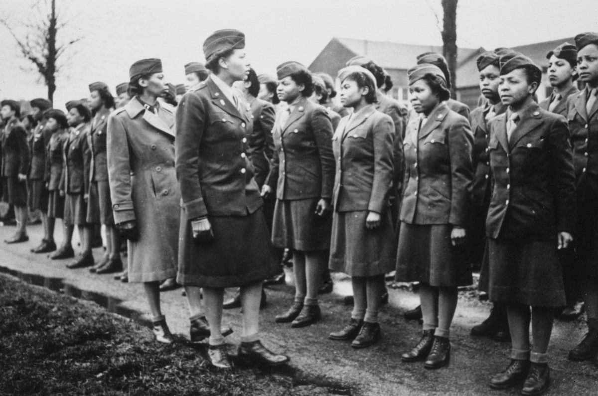 American Women's Army Corps (WAC) Captain Mary Kearney and American WAC Commanding Officer Major Charity Adams inspect the first arrivals to the 6888th Central Postal Directory Battalion at a temporary post in Birmingham, West Midlands, England, in February 1945.