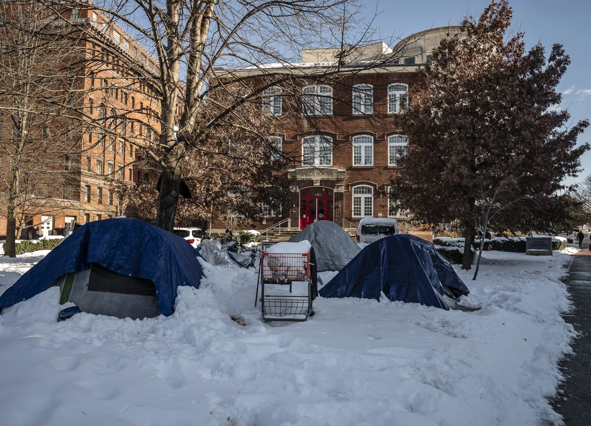 Unhoused people sleep in tents outside of Central Union Mission.