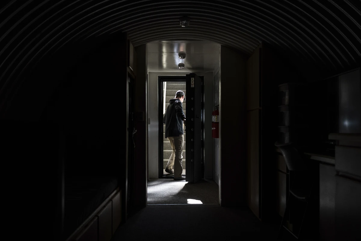 The owner, who asked not to be identified because of concerns about his privacy, closes the heavy metal door of his underground shelter in an undisclosed Southern California city, Monday, Dec. 16, 2024.