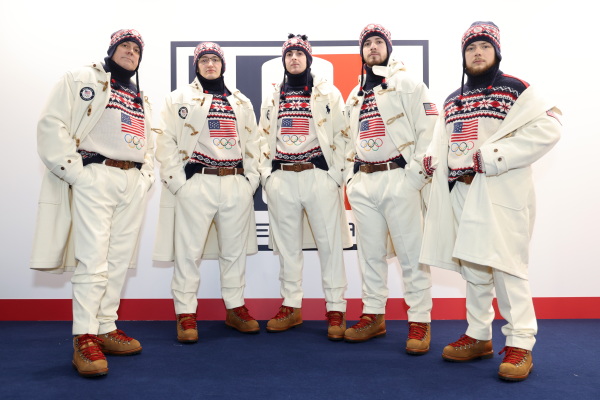 5 U.S. Olympians face the camera wearing red, white and blue sweaters and hats.